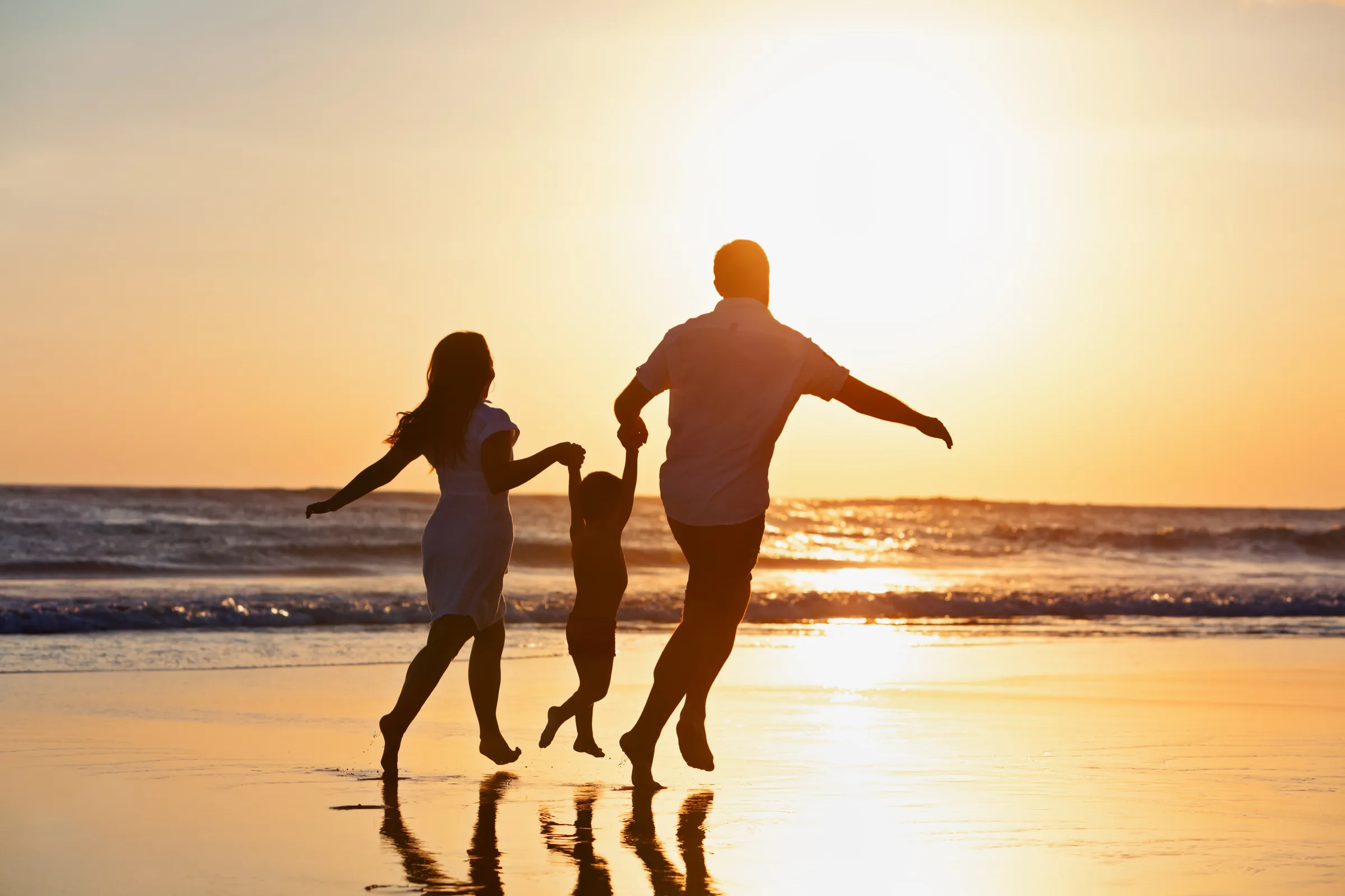 A family on the beach at sunset