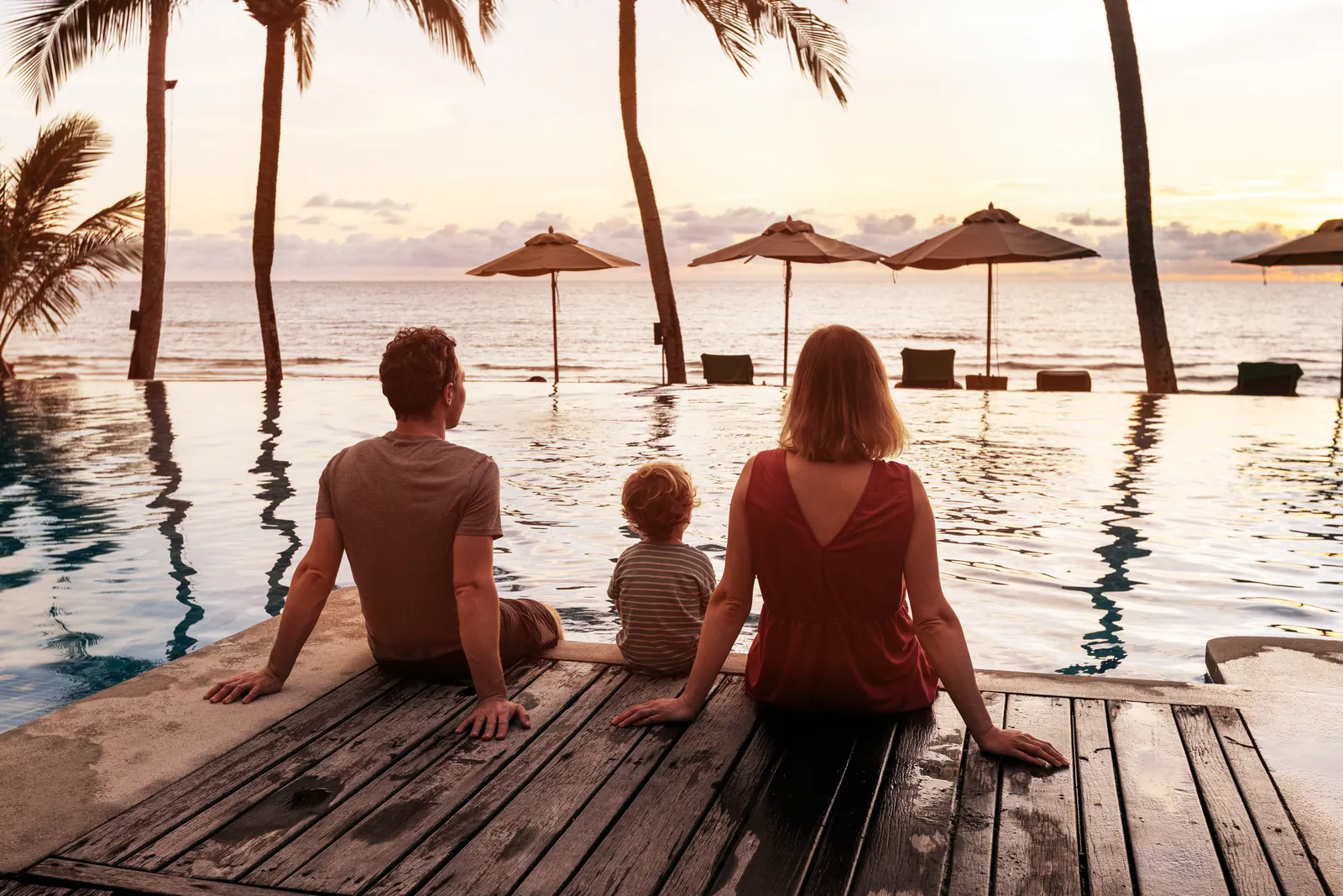 A family by a pool at sunset